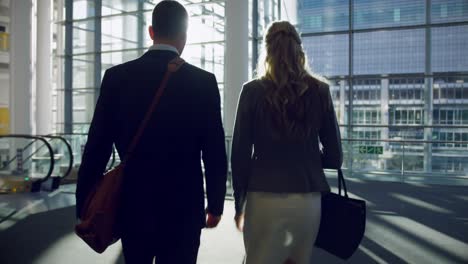 businessman and businesswoman walking together in the lobby at office 4k