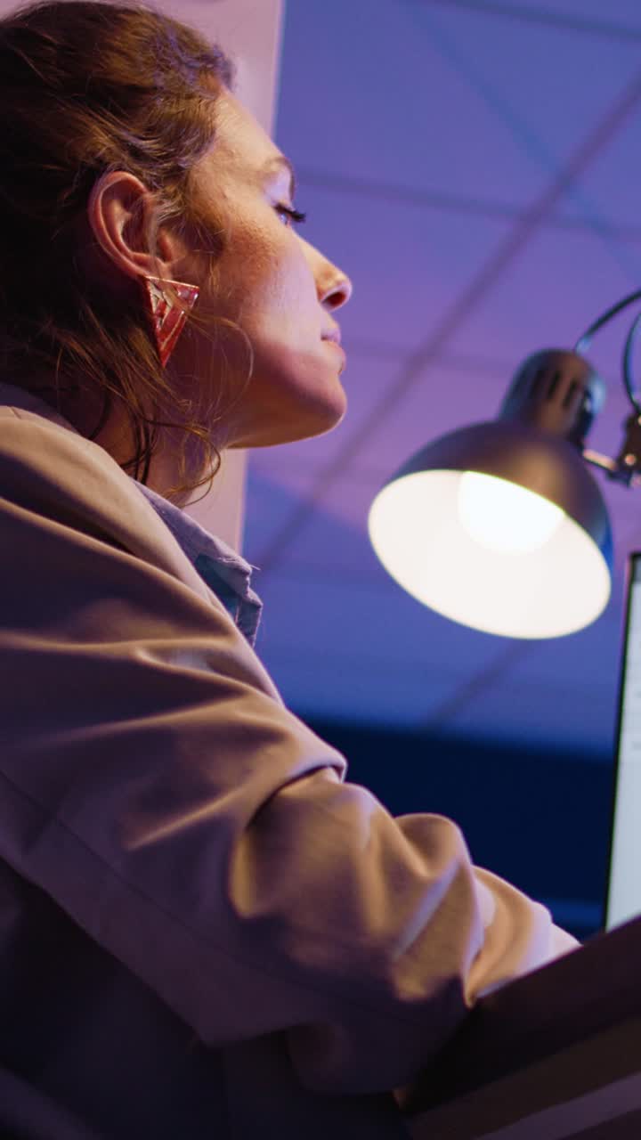Vertical video: Executive manager typing data on computer
