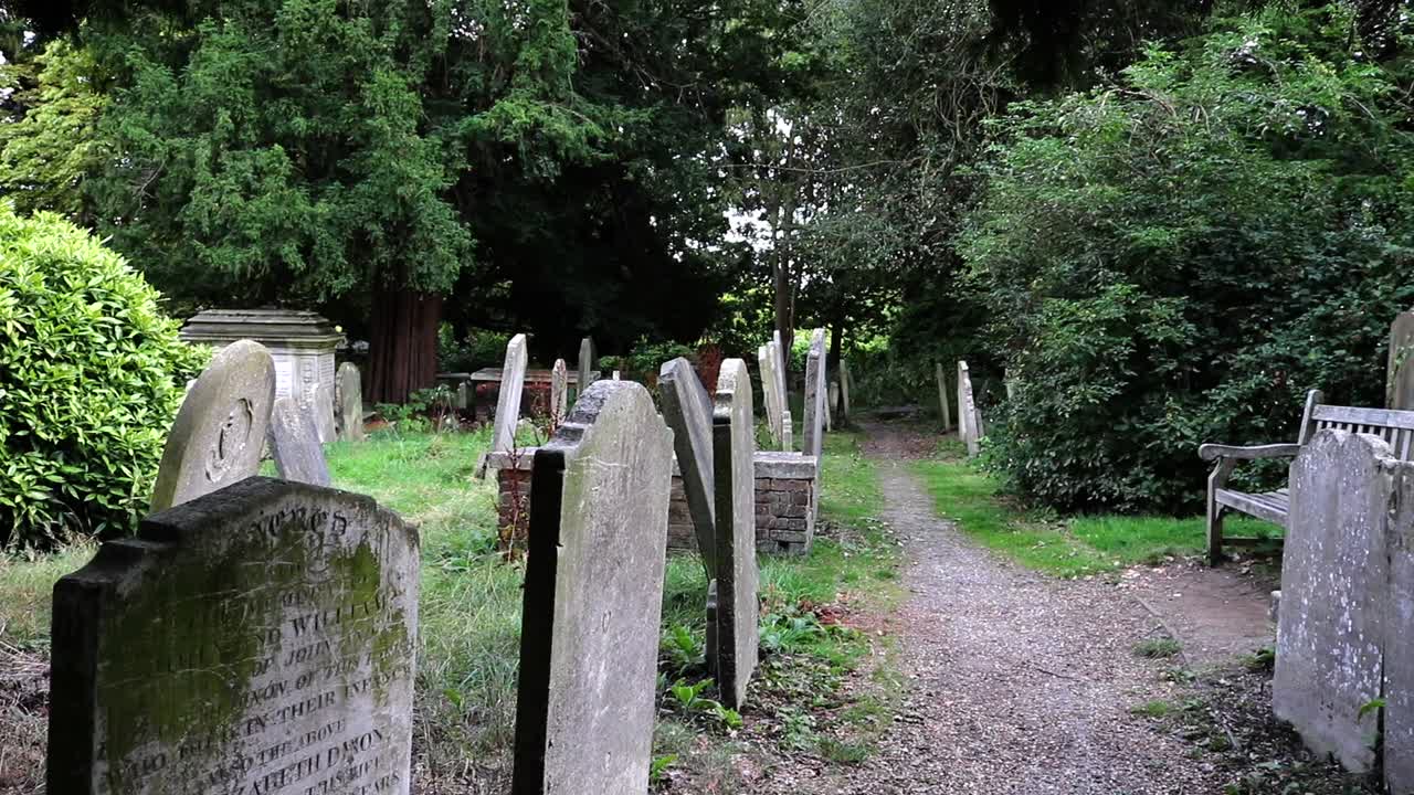 St Johns Hampstead mossy Church Graveyard tombstones tilted in a row