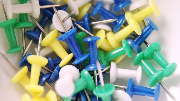 Colorful push pins in bowl 4k