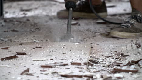 jack hammer destroying ceramic tile floor in slow mo