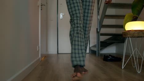 person walking barefoot in a home interior
