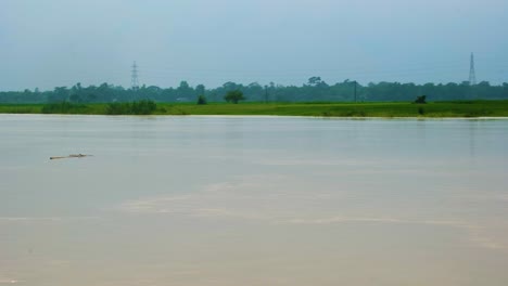 overflowed flooded river beside farmland in rural bangladesh