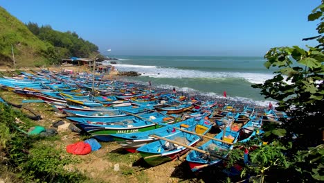 Static-shot-of-blue-fisherman-boats-on-the-sand-at-Menganti-Beach