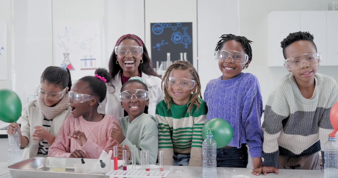 African American woman teacher leading kids in lab, teaching, balloon inflating by bottle