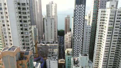 Mega-residential-buildings-and-traffic-in-downtown-Hong-Kong,-Aerial-view