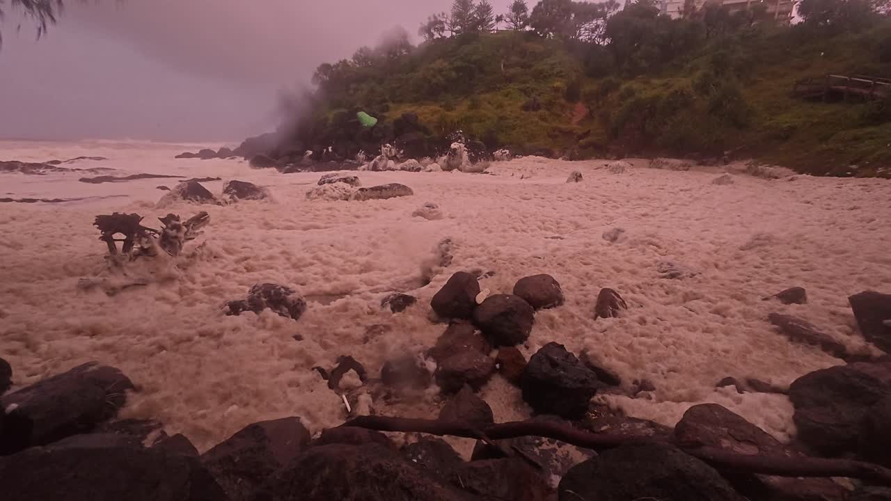 Sea Foam And Wind Blowing On Dark Gloomy Day. Cyclone Alfred At Snapper Rocks In Queensland, Australia. panning shot