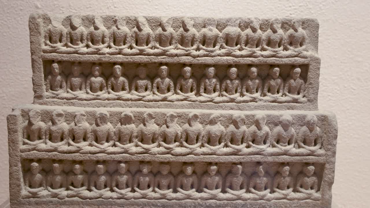 historic carving illustrating Sahastra Buddha at indoor