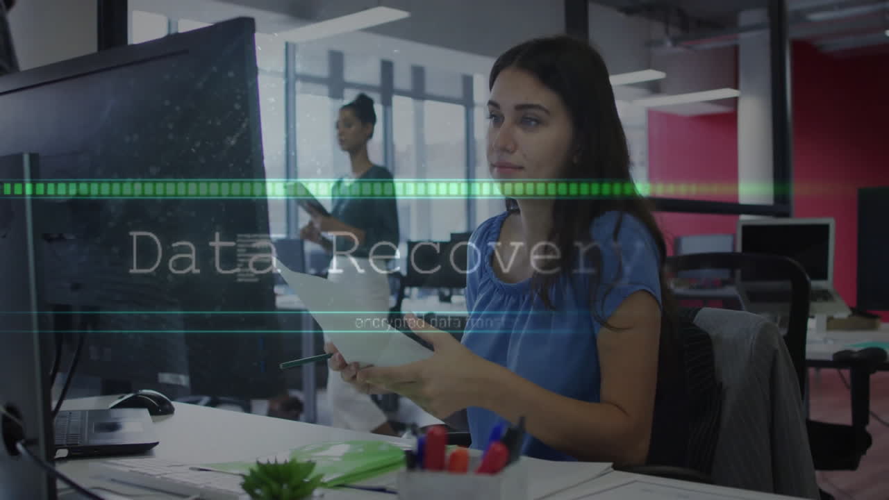 woman reviewing documents at business desk, colleague holding tablet, encrypted data bars floating