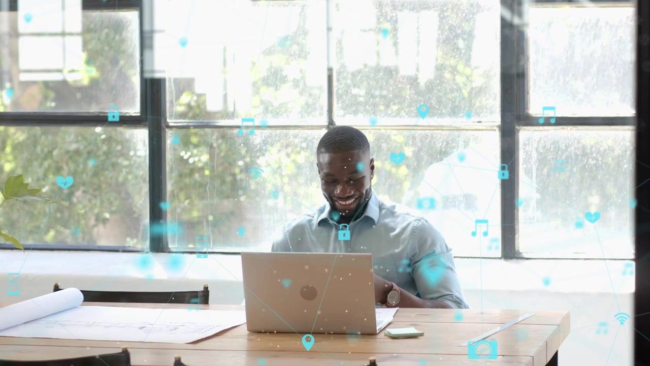 Man sitting at wooden table noticing overlay icons growing and responding on laptop for marketing