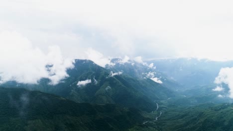 Cinematic-scenery-of-high-mountains-in-India-covered-by-fog-and-clouds-on-autumn