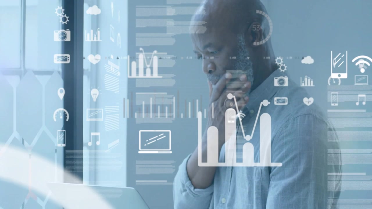 Man typing on laptop starting overlaying business HUD camera panning studying charts for decisions