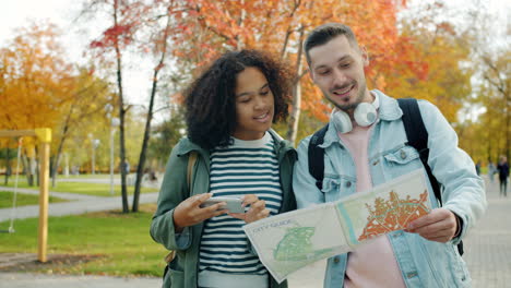 young couple exploring a city park with a map