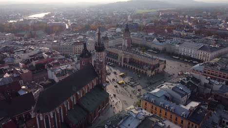 stunning aerial approach of krakow historic market square, golden hour