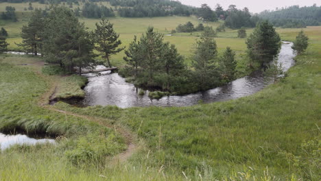 An-amazing-beautiful-landscape-view-of-a-zigzag-river-streaming-in-the-green-fields