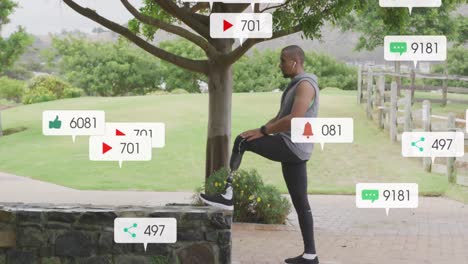 animation of social media notifications, african american man with prosthetic leg stretching in park