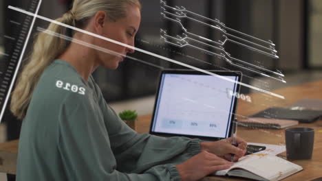 Woman writing in notebook with digital data processing animation over tablet screen