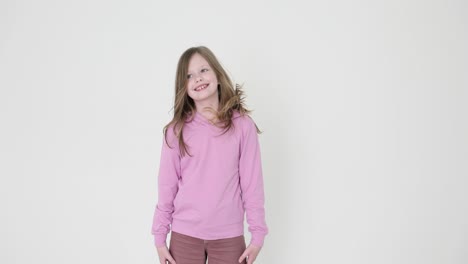 happy young girl in pink hoodie on white background