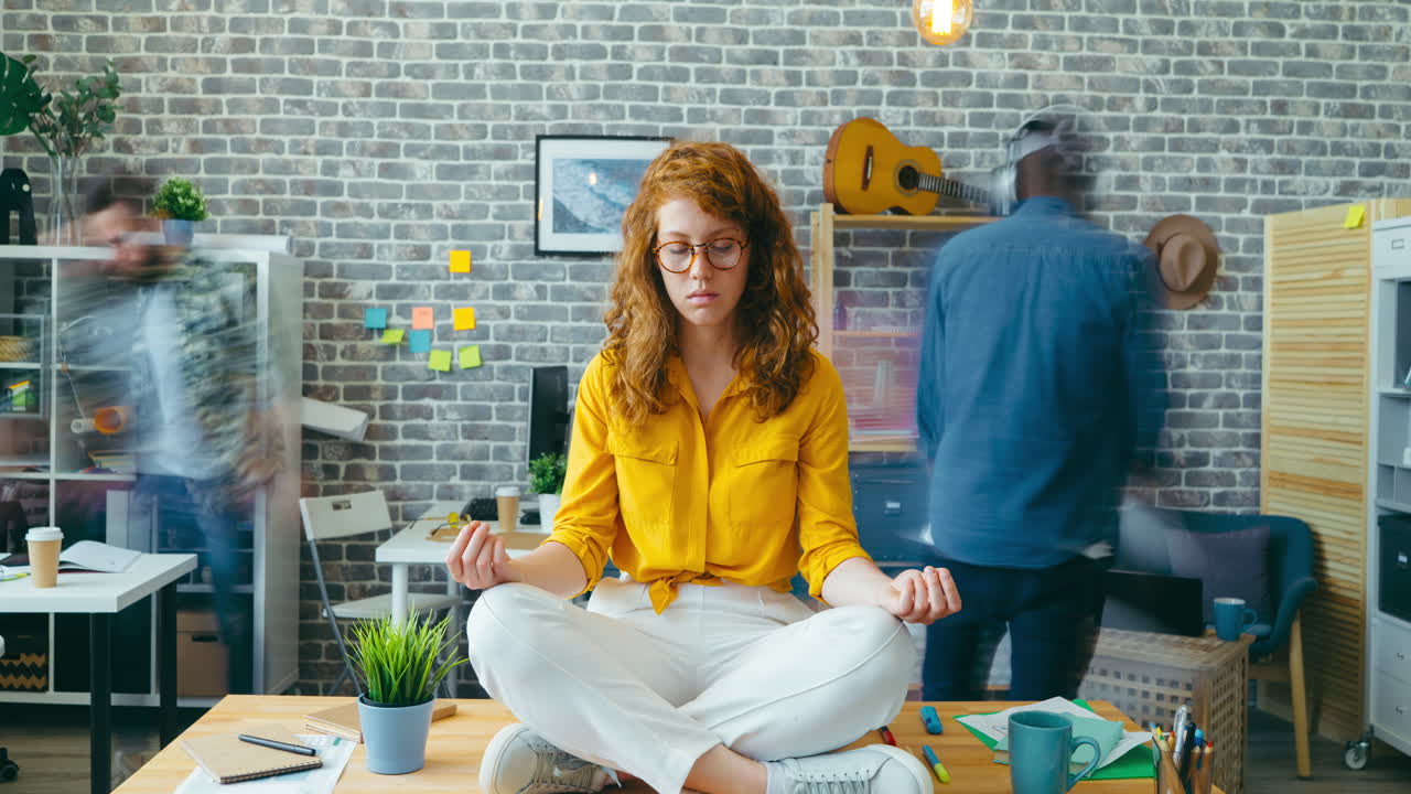 Woman Meditating in Busy Office