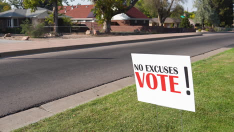 election voter rally sign next to empty road with no cars driving by, no excuses vote