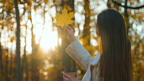 woman enjoying autumn scenery with a coffee cup