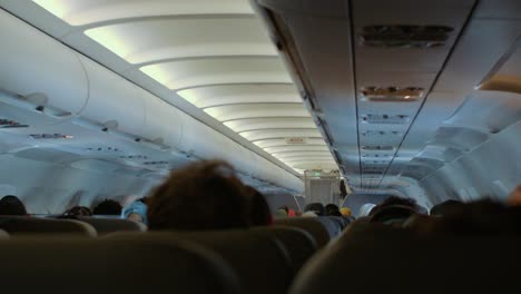 passengers sitting inside airline cabin during flight - airbus a319