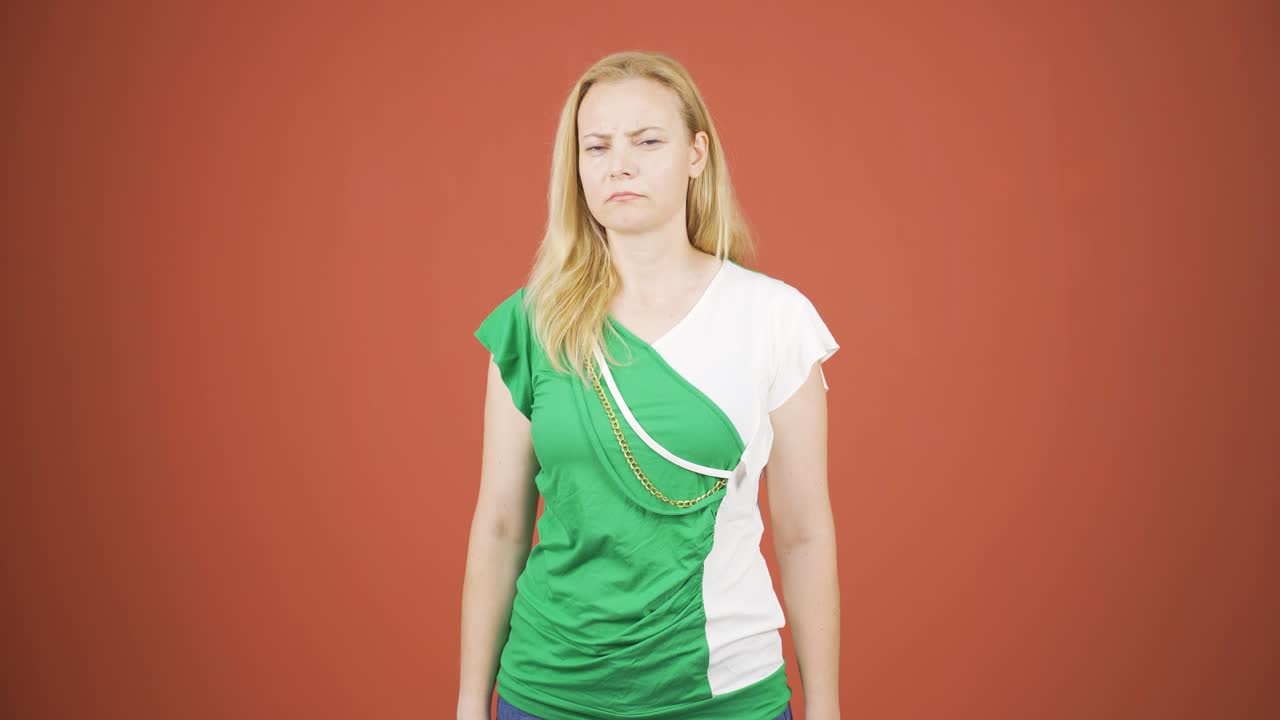 여성이 카메라를 위해 정지 표지판을 만들고 있습니다.