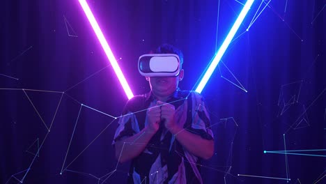 vr, futuristic, entertainment concept. excited asian boy using virtual reality headset and feel scary with neon light at the background