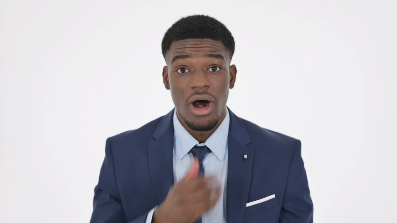 Shocked African Businessman on White Background