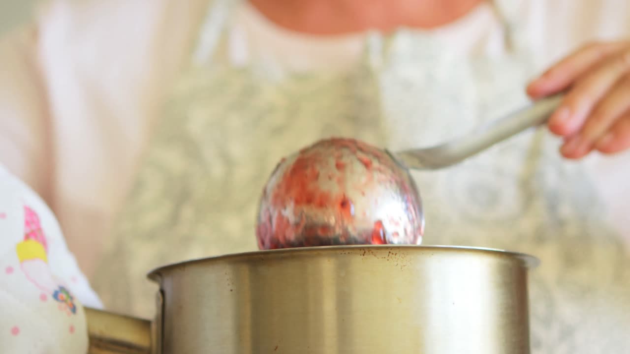 Mid-section of senior woman preparing jam