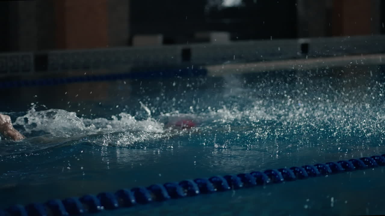 A swimmer in a pool training for a competition
