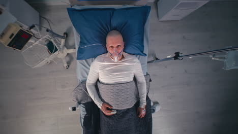 Patient in Hospital Bed with Oxygen Mask