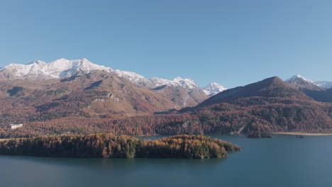 aerial drone shot colorful trees and turquoise lake in the autumn landscape. large colorful autumn fir forest.