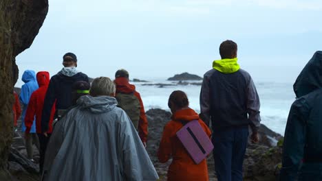 group hiking along a rocky coastline