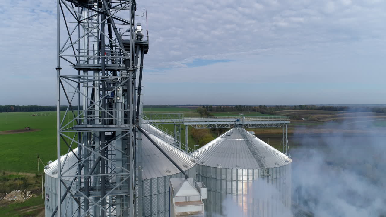 Silos big industrial factory containers. Modern huge metal constructions. Aerial view.