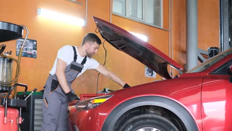 american mechanic working in a car service center american mechanic working in a car service center repair and maintenance of electric vehicles video