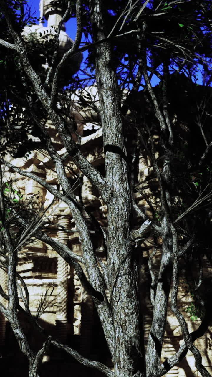 Majestic ancient architecture surrounded by lush greenery under clear sky