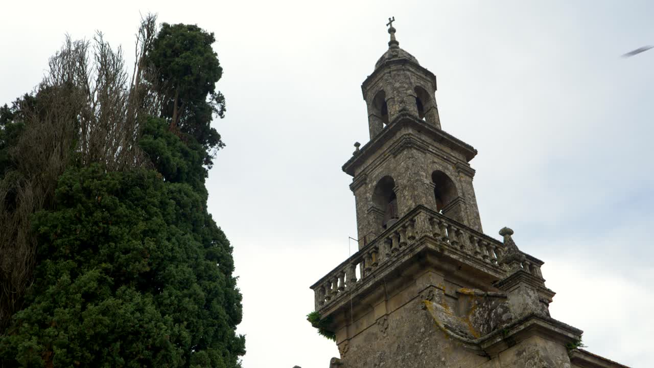 Close up of church bell tower on Santo Eusebio da Peroxa in Coles, Galicia, Spain, with cloudy background