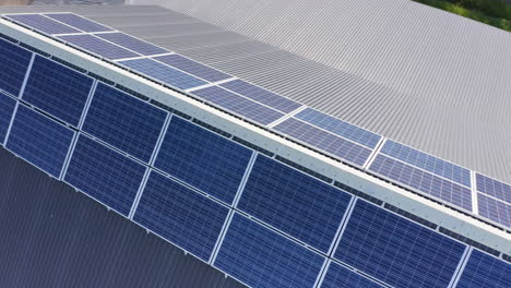 downward drone view of solar panels mounted on either side near roof ridge