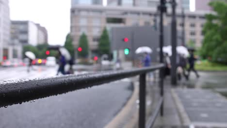 walking people on the street in marunouchi tokyo rainy day