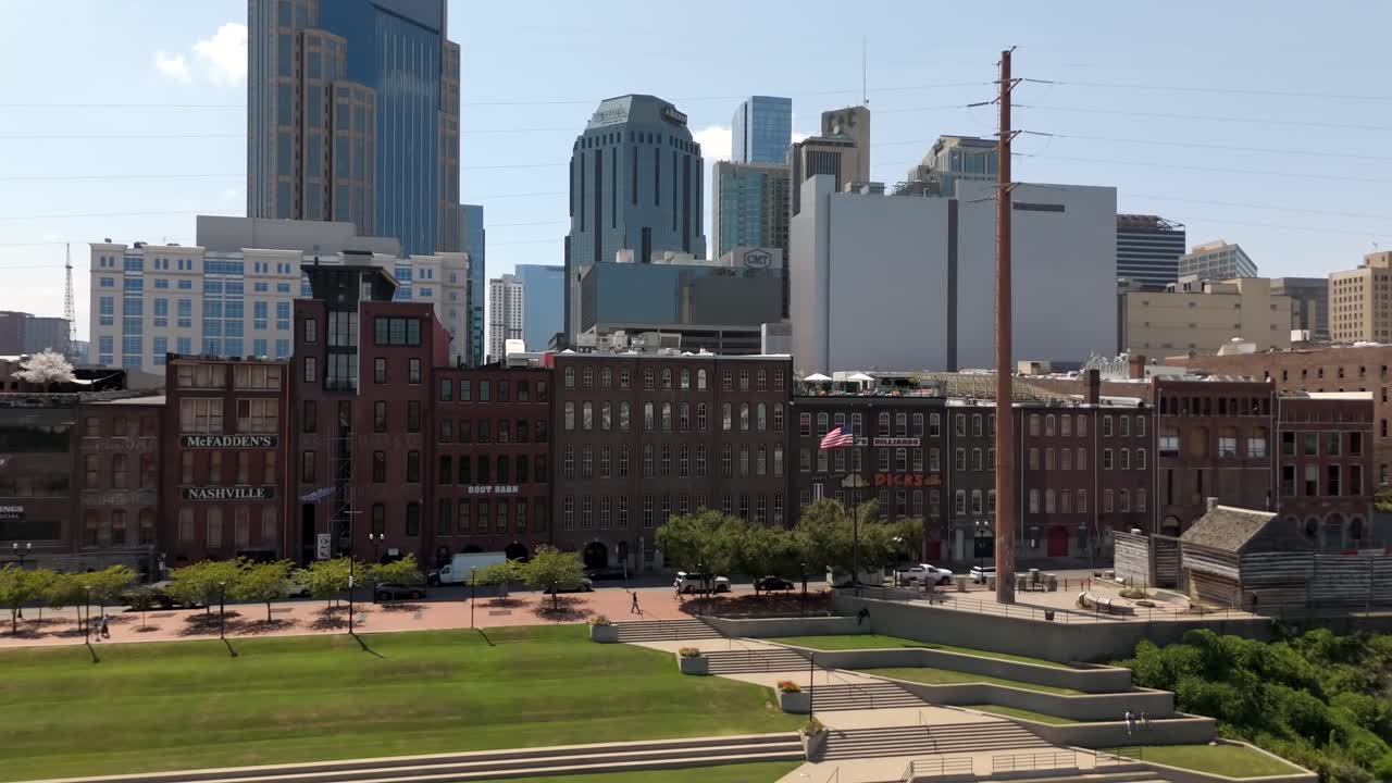 Downtown Nashville, Tennessee city skyline on a sunny day - ascending aerial view