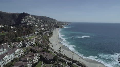 cinematic drone shot pan up from luxury hotel to ocean view in laguna beach, california. shot in 4k.