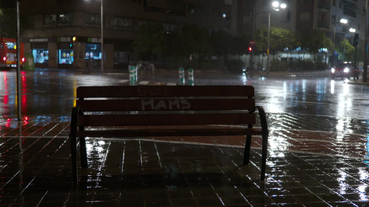 Empty bench and road traffic in the city at rainy night | Premium Stock ...