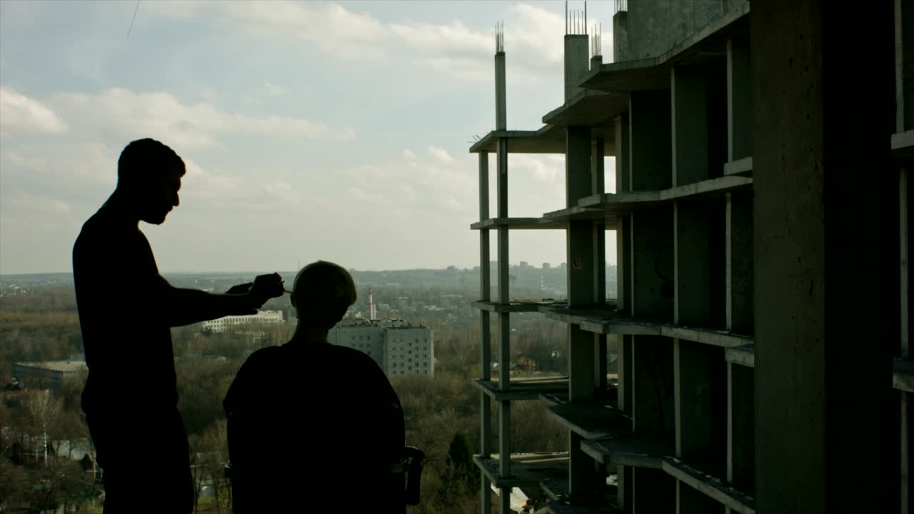 Young woman getting a haircut outdoors