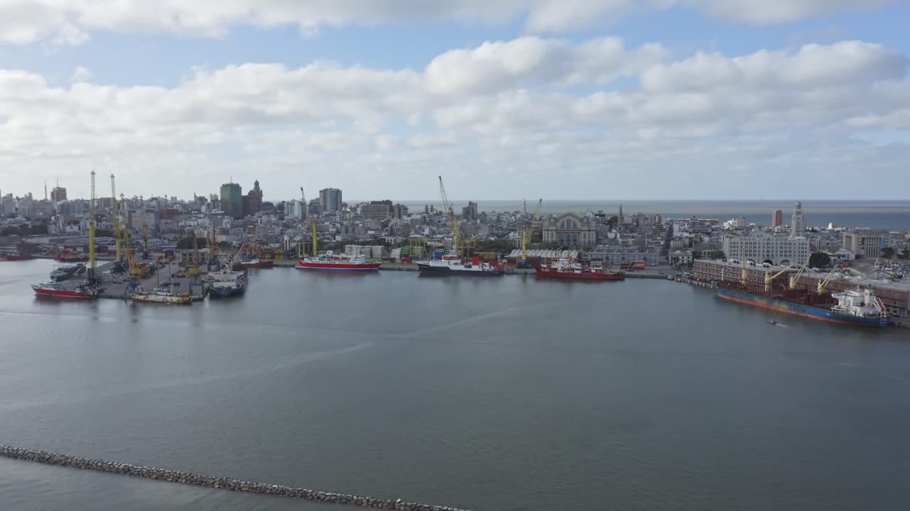 Uruguay capital city Montevideo. Right panning aerial drone view of barrio Ciudad Vieja, seen from above the port. Calm cloudy weather