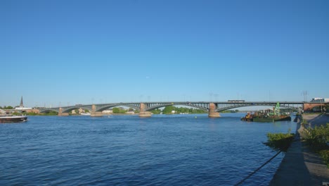 panorama shot of the theodor heuss brücke bridge between the cities mainz and wiesbaden, hesse and rhineland palatinate with the river rhine and a cargo ship on a sunny summer day