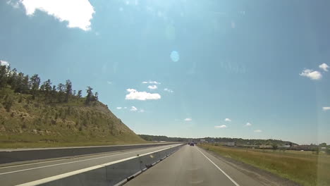 Driving-point-of-view-traveling-across-Wyoming-state-line-on-interstate-highway