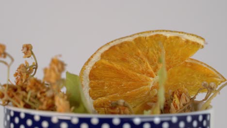 herbal remedy dried linden flower and orange in mug