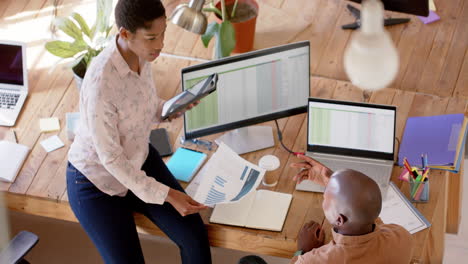 african american business professionals discuss work in an office