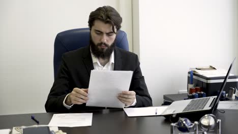 businessman reading documents in office